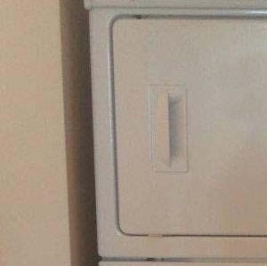 Interior a white refrigerator and a white toilet in a room
