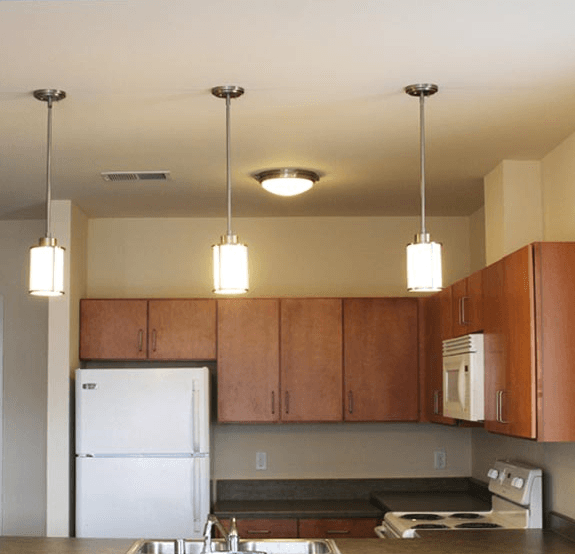 Interior a kitchen with wooden cabinets and a white refrigerator