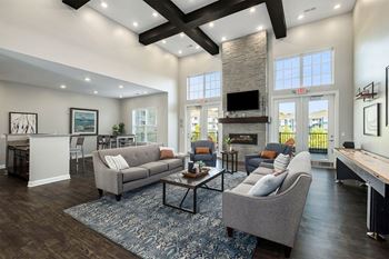 A modern living room with a grey sofa and a coffee table.