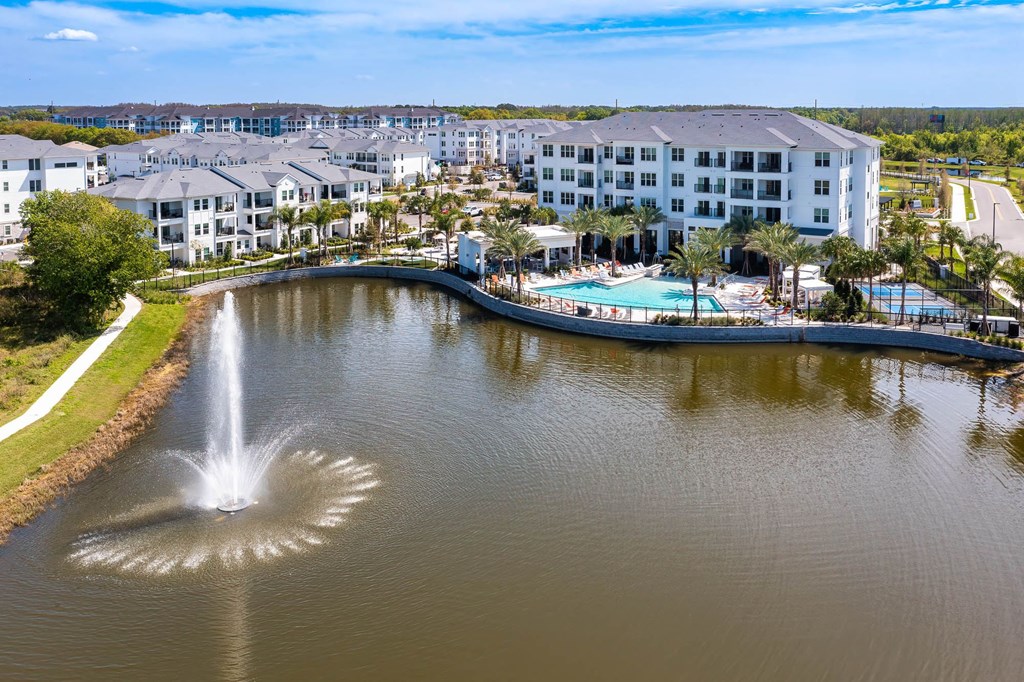 a view of a body of water with a hotel and a fountain