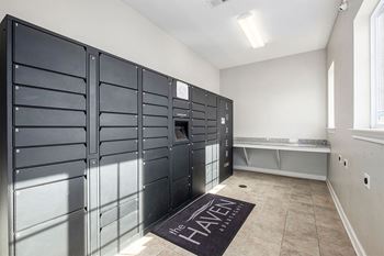 A room with a row of black lockers on the wall and a mat on the floor that says "The Haven".