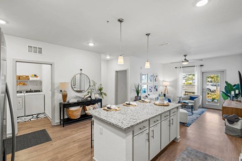 A modern kitchen with white cabinets and a large island.