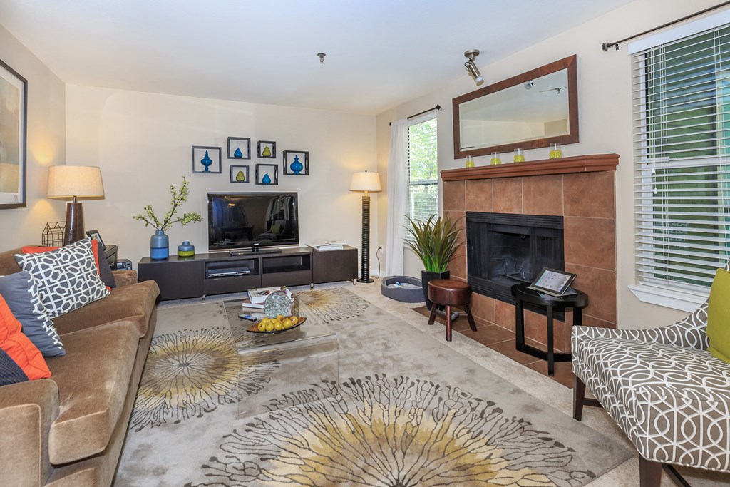 a living room with a fireplace and a tv