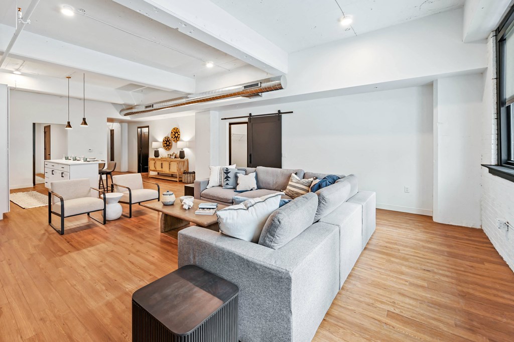 a living room filled with furniture and a large window