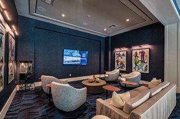A living room with a television and comfortable seating at Altis Santa Barbara, Florida