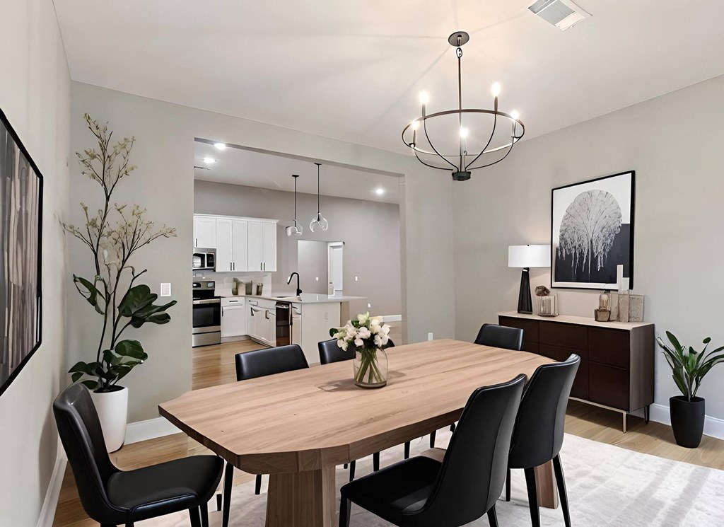 a dining room with a wooden table and chairs