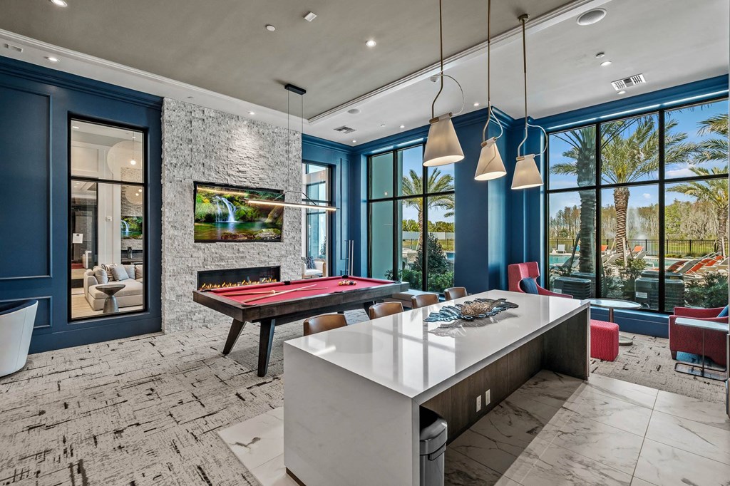a game room with a pool table and blue walls