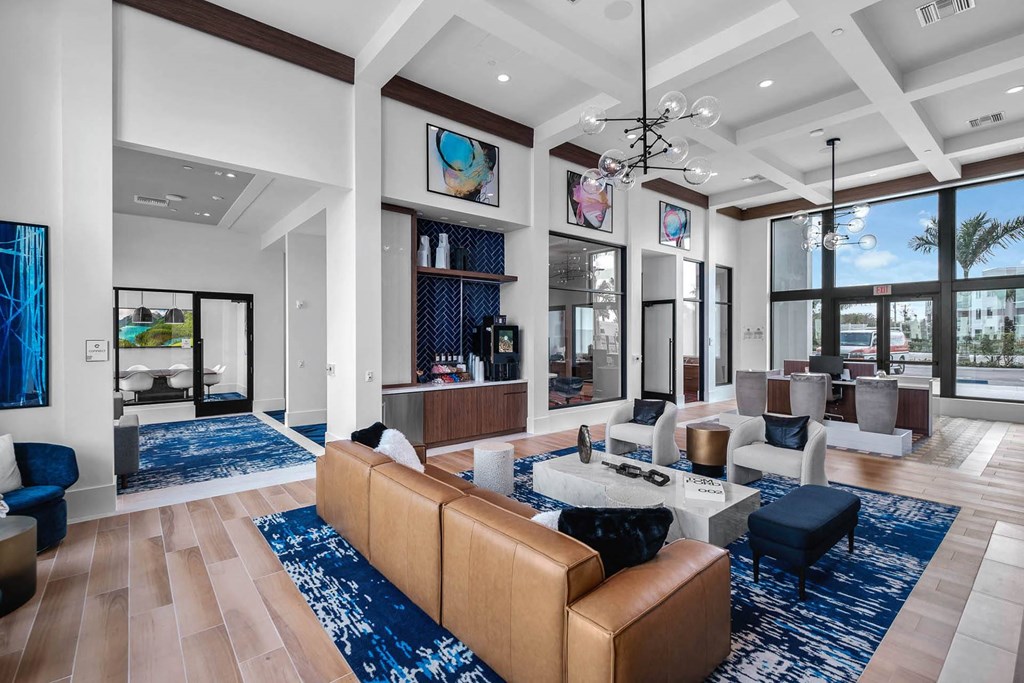 a living room with couches and chairs and a table at Altis Blue Lake, Lake Worth, 33467