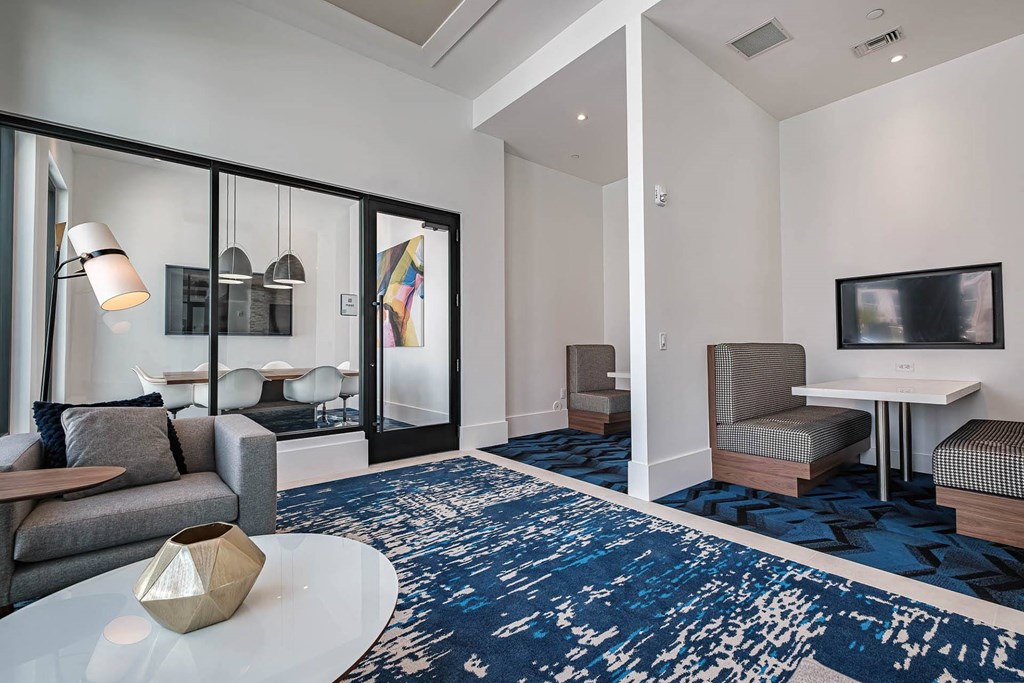 a living room with a couch and a table at Altis Blue Lake, Florida, 33467