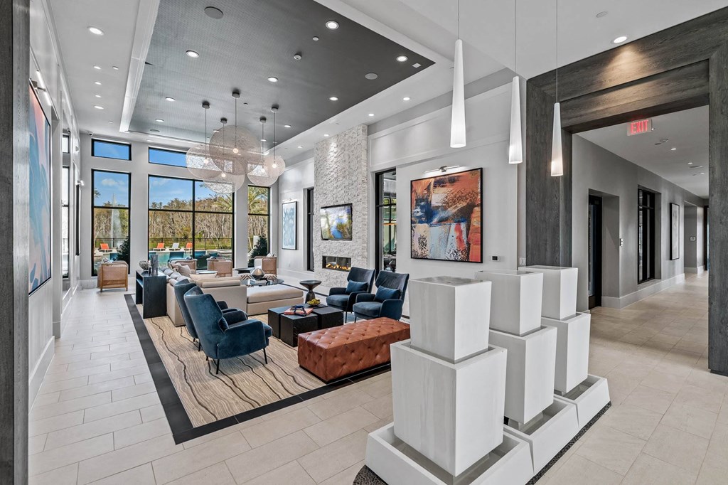 a lobby with couches and chairs and a reception area