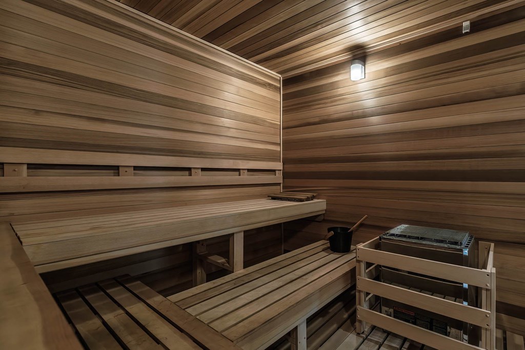 a sauna with wooden benches and a table