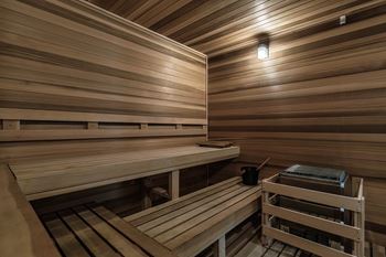 a sauna with wooden benches and a table at Altis Grand Suncoast, Land O' Lakes, 34638