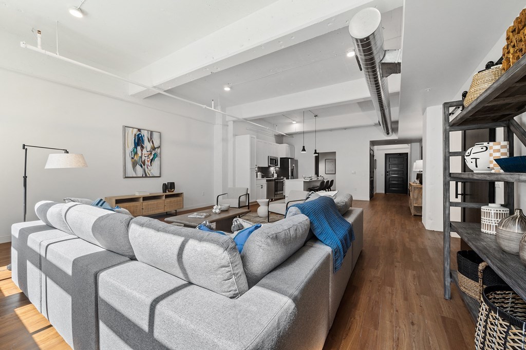 a living room filled with furniture and a large window