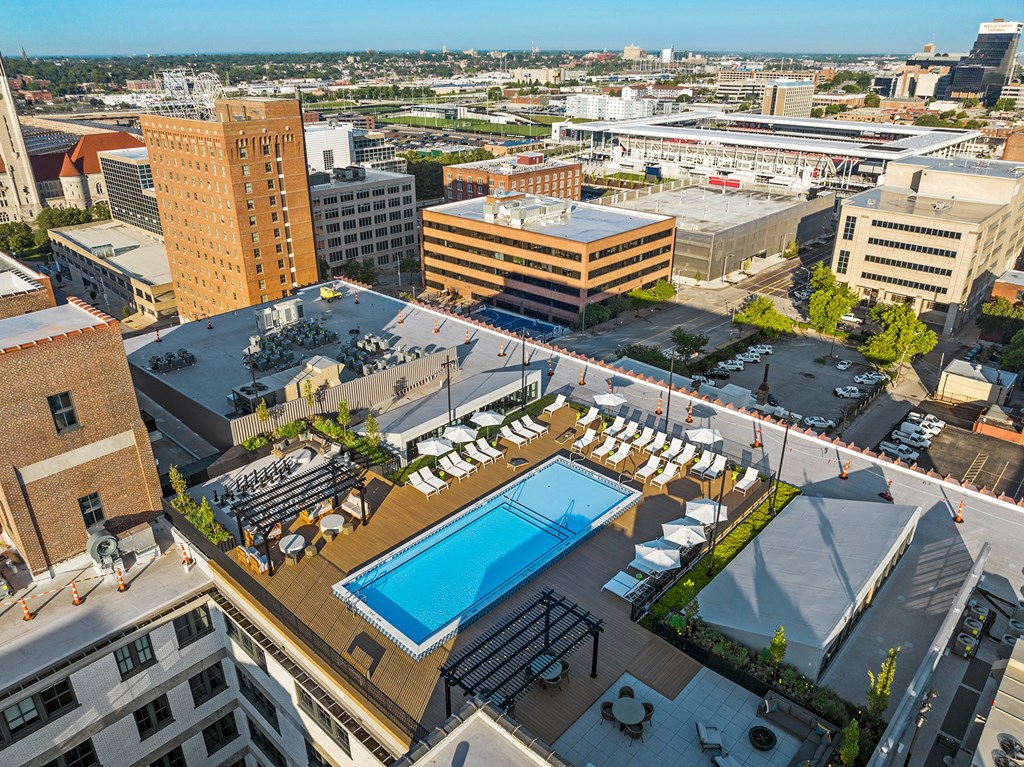an aerial view of a pool and city buildings