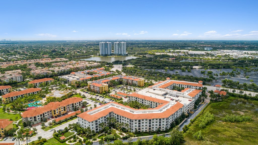 an aerial view of a city with tall buildings and a lake