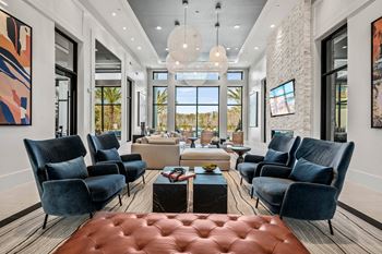 a living room with couches and chairs and a table at Altis Grand Suncoast, Land O' Lakes Florida