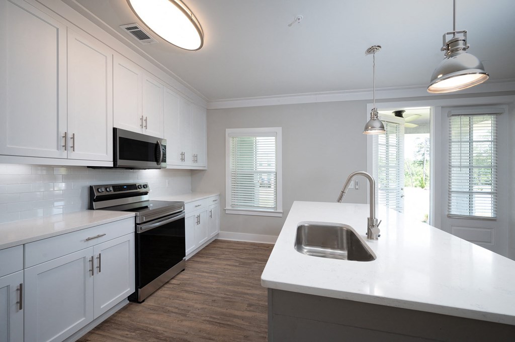 a kitchen with white cabinets and a white counter top