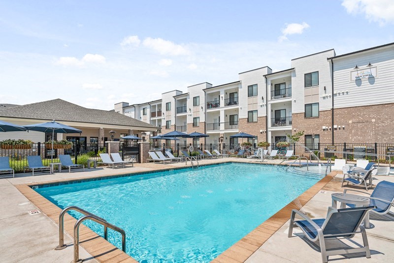 our apartments offer a swimming pool with chairs and umbrellas