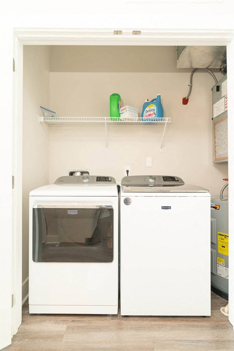 a small laundry room with two washes and a dryer