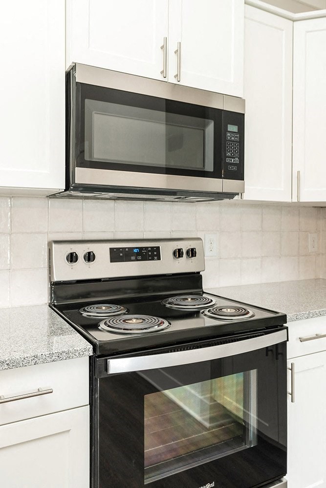 a kitchen with a stove and a microwave