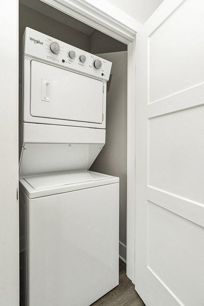 a washer and dryer in a closet next to a door