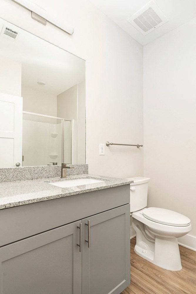 a bathroom with a toilet and a sink and a mirror
