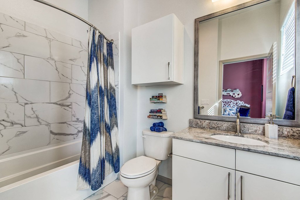 Apartments for Rent Lewisville - Hebron 121 Station - Bathroom With Tile Flooring, Cabinets, and a Modern Shower