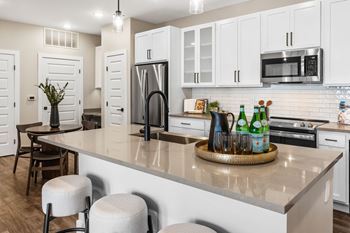 an open kitchen with a large counter with a center island