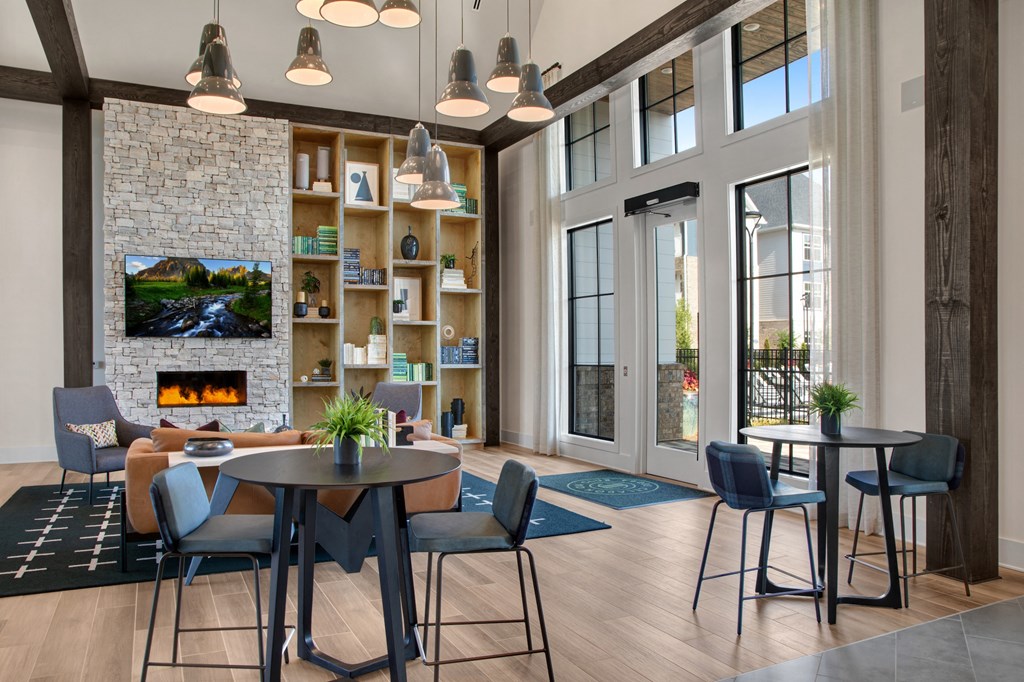 a room with tables and chairs and a fireplace