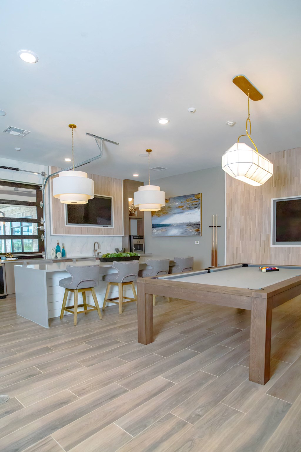 a game room with a pool table and a bar