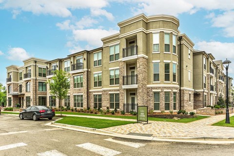 a car parked in front of an apartment building