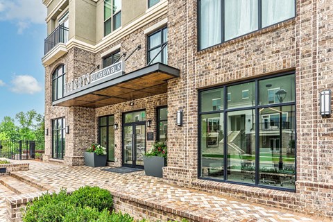a brick building with large windows and a balcony