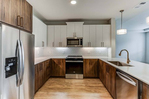a kitchen with wooden cabinets and stainless steel appliances