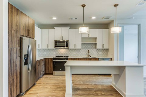 a kitchen with a white counter top and a refrigerator
