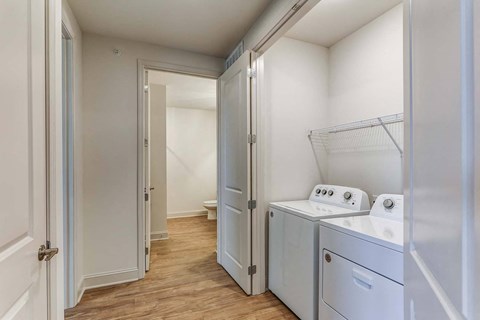 a washer and dryer in a laundry room with a closet
