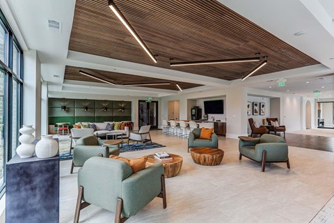 the lobby or reception area of a hotel with couches and chairs