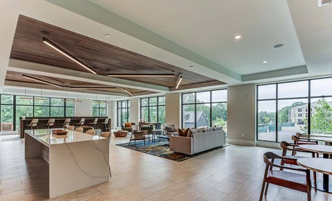 a large living room with lots of windows and a table and chairs