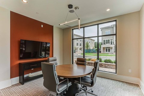 a dining room with a table and chairs and a large window