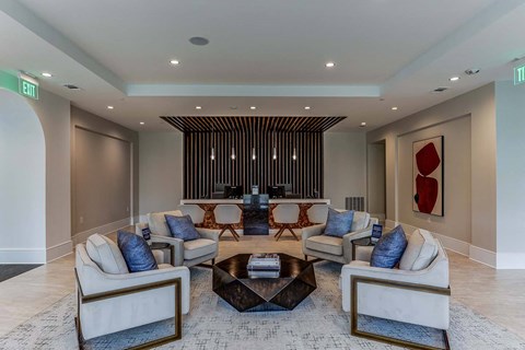 a living room with couches and chairs and a table