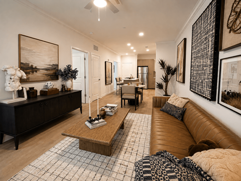 A living room with a brown leather couch and a wooden coffee table.
