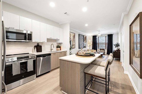 A modern kitchen with a dining table and chairs.