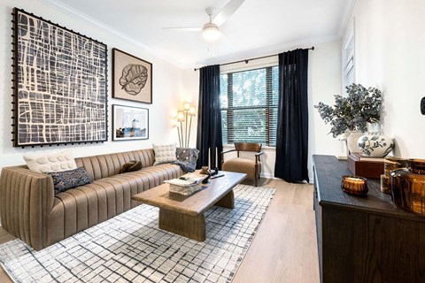 A living room with a brown sofa and a coffee table.