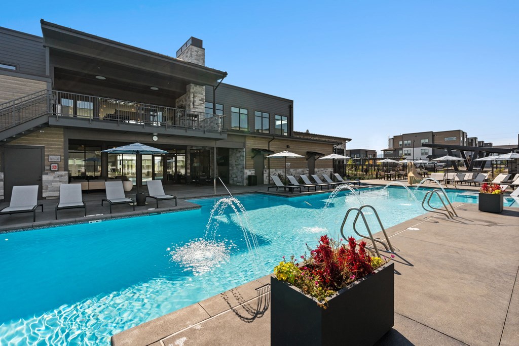 A pool area with a building in the background.