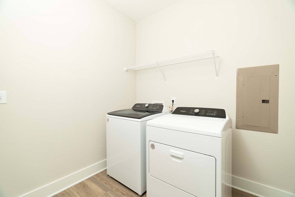 A white washing machine and dryer in a small laundry room.