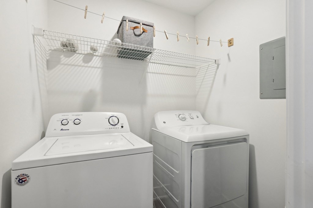 A white washing machine and dryer in a small laundry room.