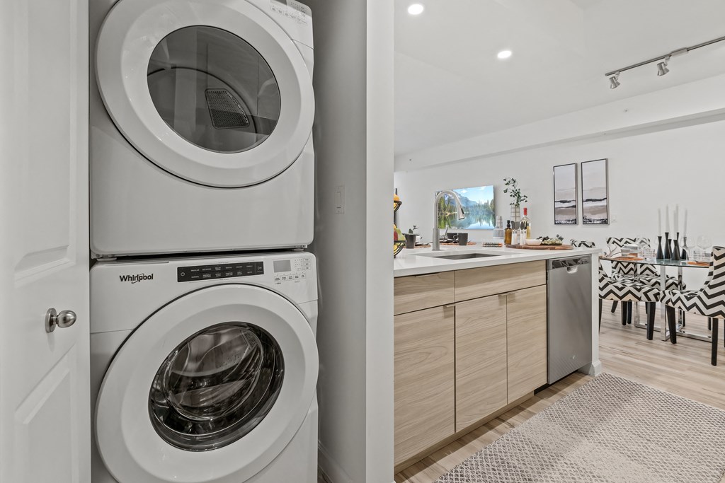 a washer and dryer sit next to each other in a laundry room at Altis Grand Lake Willis, Orlando, 32821