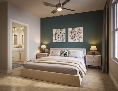 A bedroom with a large bed and two lamps.