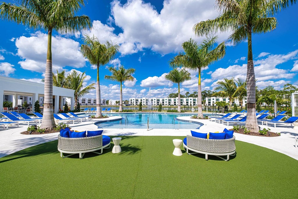 a rendering of a pool area with chairs and palm trees at Altis Blue Lake, Lake Worth, Florida
