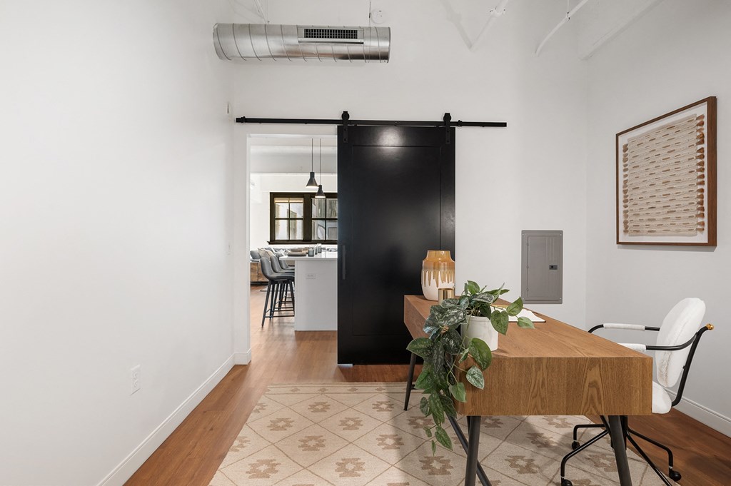 a sliding barn door separates the kitchen from the living room