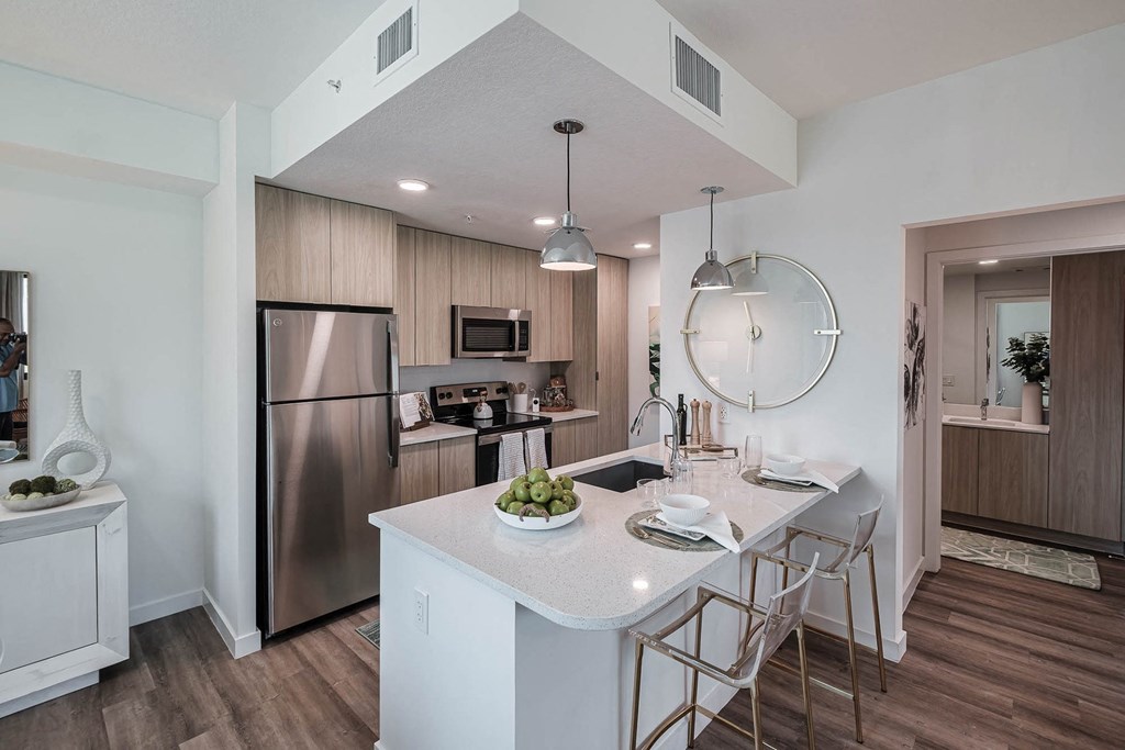 a kitchen with an island and stainless steel appliances